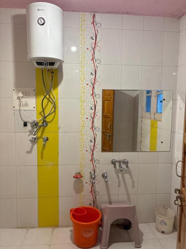 a bathroom with a shower with a sink and a mirror at Giggle in Srinagar