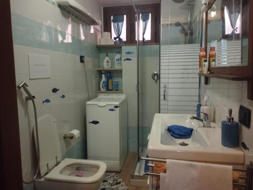 a bathroom with a sink and a toilet and a shower at La casetta del pescatore - Le case di Bettina in Torrenova