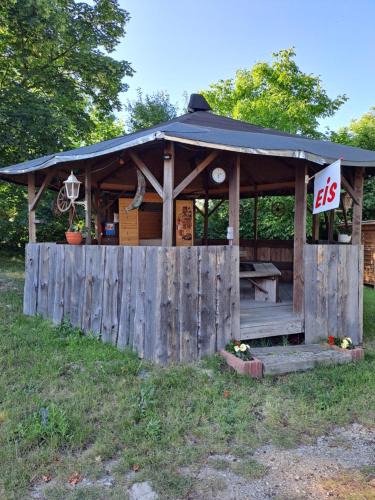 a wooden gazebo with a price sign on it at Ingos Landhaus in Schöneberg