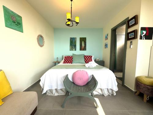 a bedroom with a bed with a pink hat on it at Shakti, Abdelli guesthouse in Batroûn
