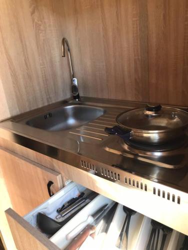 a kitchen with a sink and a pan on a counter at Chalmová CHATA 27 in Bystričany