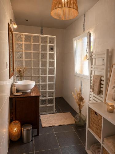 a bathroom with a sink and a glass wall at Ker Sonia in Angers