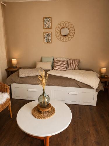a bedroom with a bed with a table in front of it at Ker Sonia in Angers