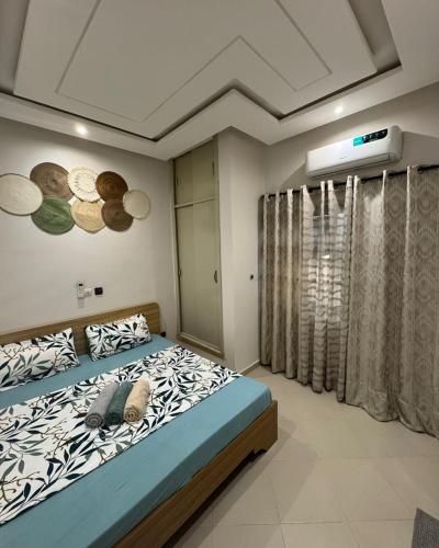 a bedroom with a bed with planets on the wall at Havenstay in Yaoundé