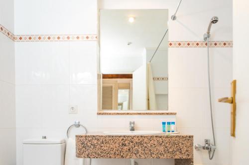 a bathroom with a sink and a mirror at RVHotels Golf Costa Brava in Santa Cristina d'Aro