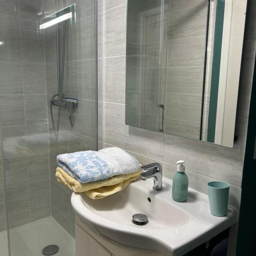 a bathroom sink with a shower and a mirror at La Maisonnette in Cellettes