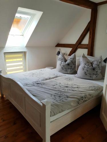 a bedroom with a white bed with pillows on it at Pferdeglück in Remptendorf