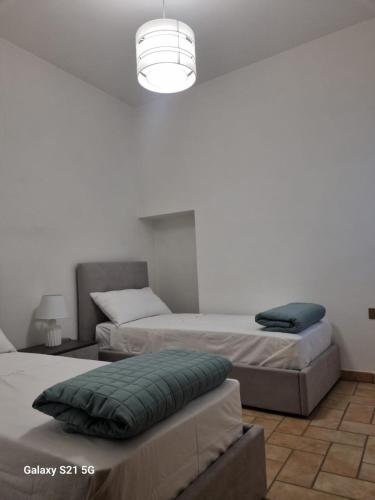 a bedroom with two beds and a light at Casale Montanari in Matigge