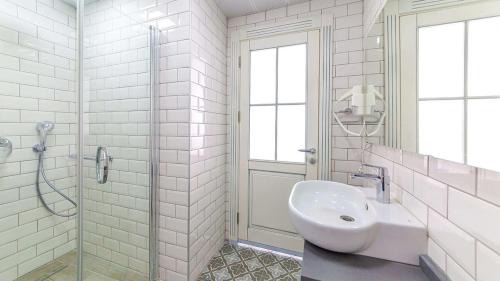 a white bathroom with a sink and a shower at Marmaris Beach Hotel in Marmaris