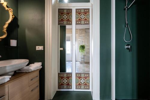 a bathroom with a glass door with a mirror at Chez Moi in Trapani