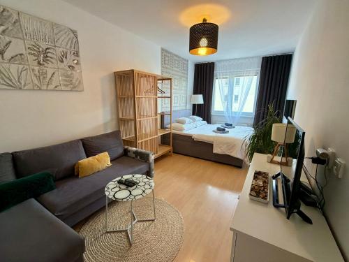 a living room with a couch and a bed at Richie Apartment near Aquapark in Prague