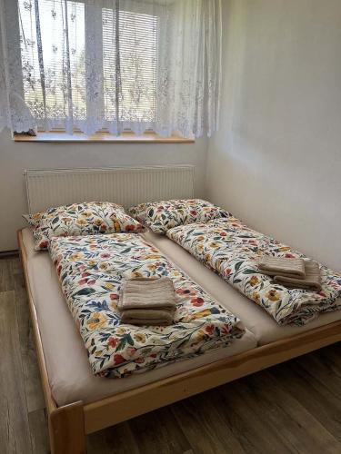 a bed with a comforter and two pillows on it at Nutilova chalupa in Jindřichŭv Hradec