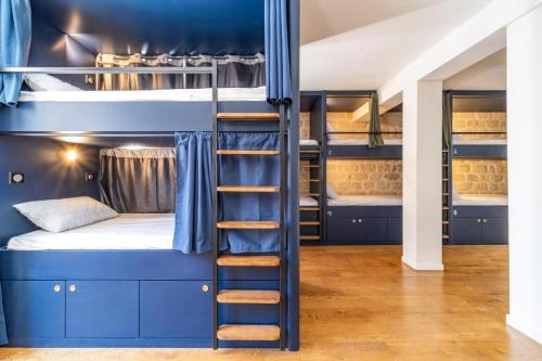 a bunk bed with a ladder in a room at FRATERNiTY-HOTEL in Paris
