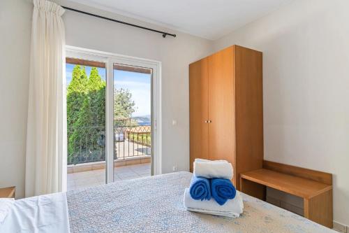 a bedroom with a bed and a large window at Villa Seliora in Sivota