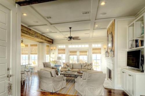 a living room with a couch and a table and chairs at Moss Landing Luxury Beachfront Private Walkover in Bolivar Peninsula