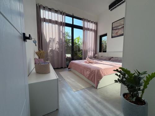 a bedroom with a bed and a large window at Noir Blanc Modern Villa in Ko Phangan