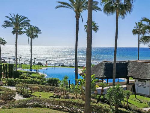 a view of the ocean from a resort at Sea View - Pool view - Beach Front - 25 meter to beach in Málaga