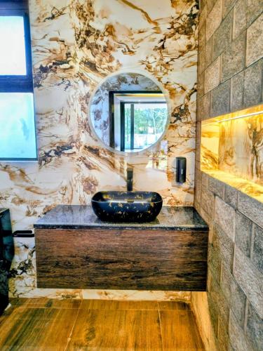 a bathroom with a sink and a mirror at ROYALTY GLOBAL HOMESTAY in Shillong