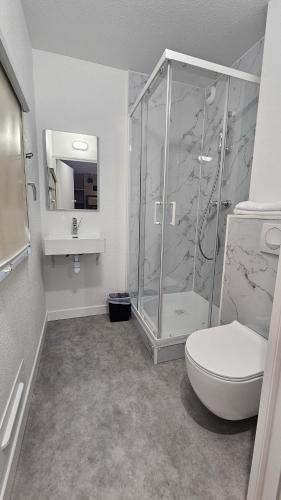 a bathroom with a shower and a toilet and a sink at Kyriad ECO - Tours Nord in Tours