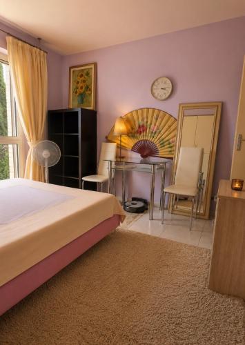 a bedroom with a bed and a table and a mirror at Home for 2 few steps from center of Monte Carlo in Beausoleil