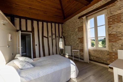 a bedroom with a large bed and a window at La tour du manoir in Arouille