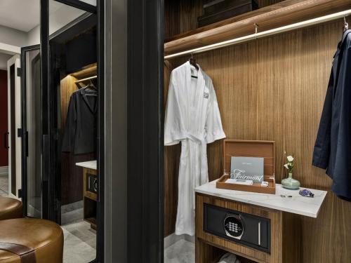 a dressing room with a white robe on a wall at Fairmont Banff Springs in Banff