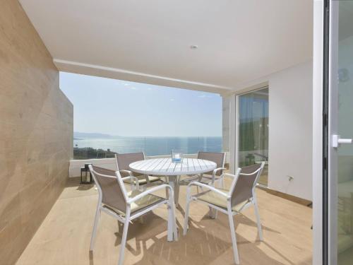 a dining room with a table and chairs at Apartamento de lujo vista mar en Torrox Costa in Torrox Costa