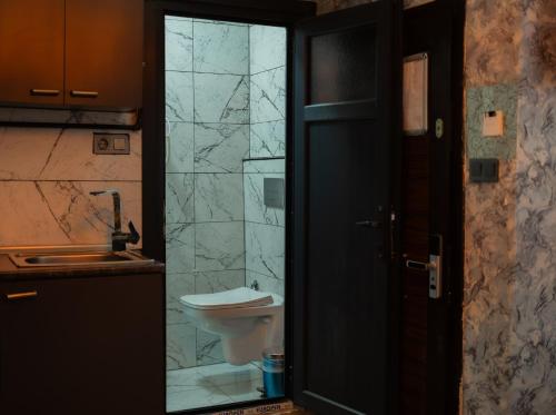 a bathroom with a toilet and a glass door at Golden Horn Life Hotel- FULL BOARD in Istanbul