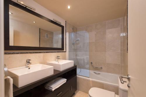 a bathroom with a sink and a shower and a mirror at Spacious 3 bedrooms apartment side sea view in Torrox Costa
