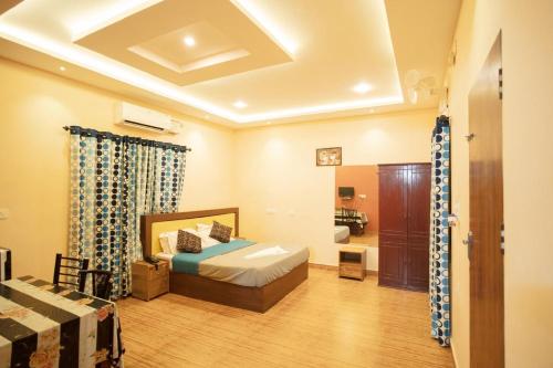 a large room with a bed and a bathroom at Misty Slope in Ambalavayal