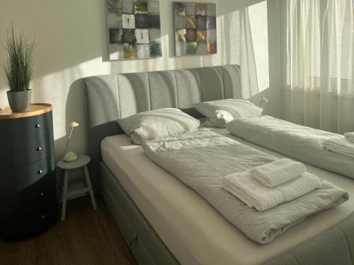 a bed with towels on it in a room at Tgesa Tgampi T20 in Savognin