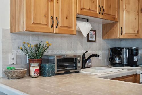 a kitchen with a counter with a microwave on it at Cozy Hillside Cottage Overlooking Main Street in Park City