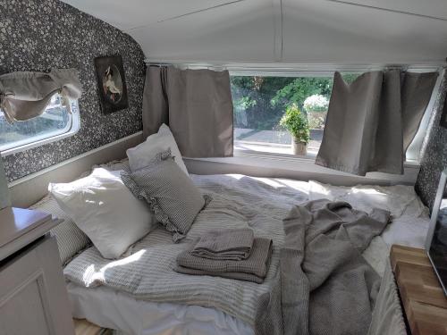 a bed in the back of a camper van at The running Rabbit caravan in Ystad