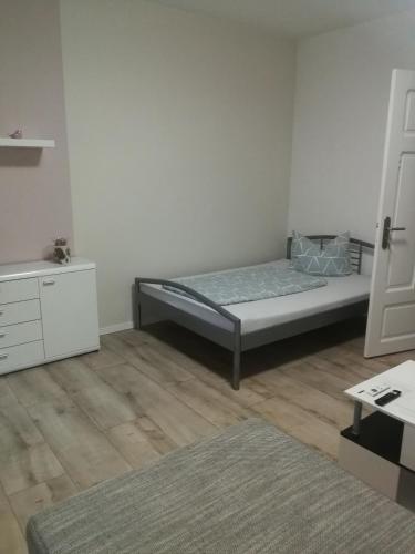 a bedroom with a bed and a white wall at Lindenblüte in Seehausen