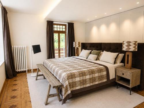 a bedroom with a large bed and a window at Villa Flora 1909 - Private Alpine Residence in Grindelwald
