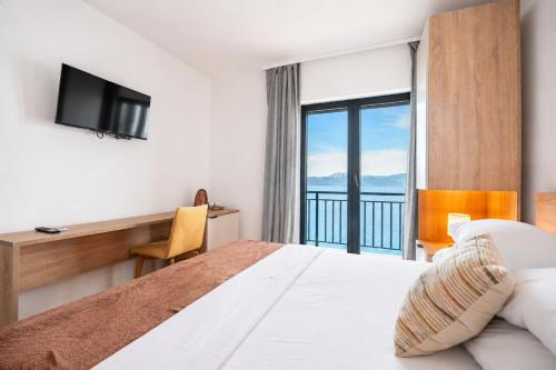 a hotel room with a bed and a balcony at Galeb Bed and Breakfast in Baćina
