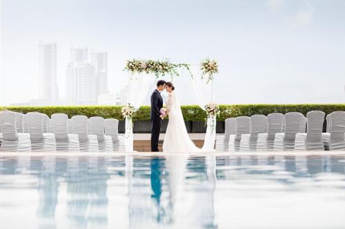 a bride and groom kissing at their wedding ceremony at China Hotel Guangzhou - Subway direct to Pazhou Exhibition Center, Free shuttle during Canton Fair & Exhibitor registration Counter in Guangzhou
