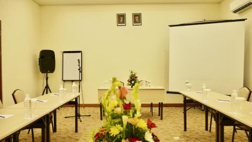 a conference room with tables and a podium in the middle at Zia Hotel Kuta in Kuta