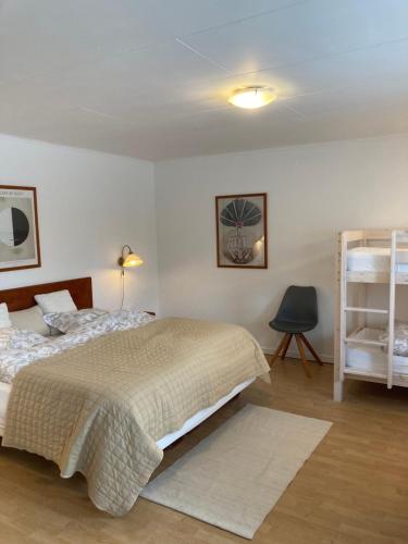 a bedroom with a bed and a book shelf at Børglum Mejeri Hotel B&B in Børglum