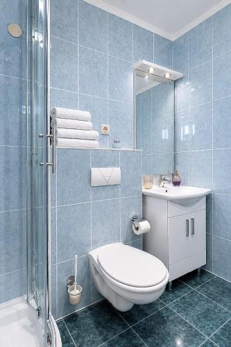 a bathroom with a toilet and a sink and a shower at Galeb Bed and Breakfast in Baćina
