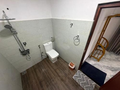 a small bathroom with a toilet and a shower at Duo Haven Inn Ella in Ella
