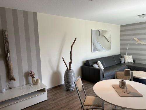 a living room with a couch and a table at Eastside 2 am Kurpark in Scharbeutz