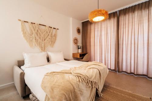 a bedroom with a bed and a large window at Boho Apartment with Sea View & Pool in Baošići