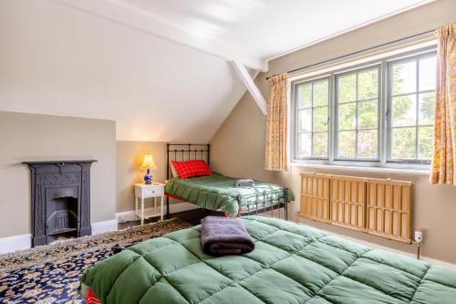 a bedroom with a green bed and a fireplace at 2 Bed in Minehead oc-77363 in Withypool