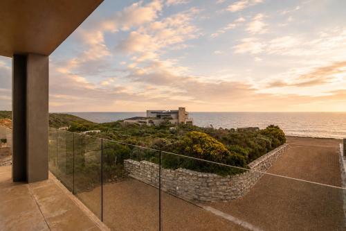 a view of the ocean from the balcony of a house at Peninsula Villa - Romansbaai in Gansbaai