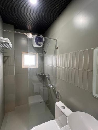 a bathroom with a shower and a toilet and a sink at Kaizen Living in Guwahati