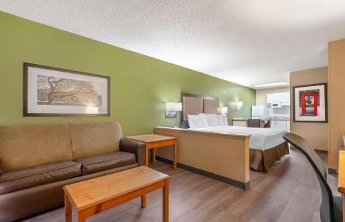 a hotel room with a bed and a couch at Extended Stay America Suites - Portland - Tigard in Tigard