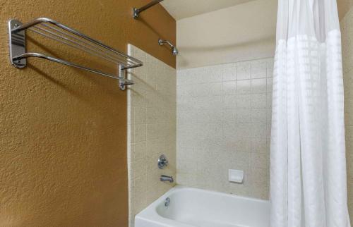 a bathroom with a shower curtain and a white tub at Extended Stay America Suites - Portland - Tigard in Tigard