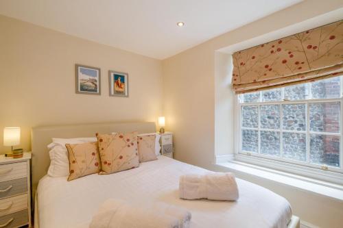 a bedroom with a white bed and a window at 2 Bed in Cromer oc-2309 in Cromer