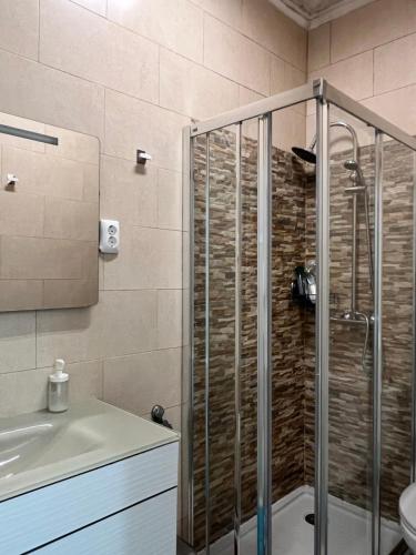 a bathroom with a shower and a sink at Quarto confortável in Amadora